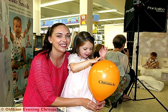 ENTERING the contest . . . Emily Douglas gets her picture taken with mum Emma