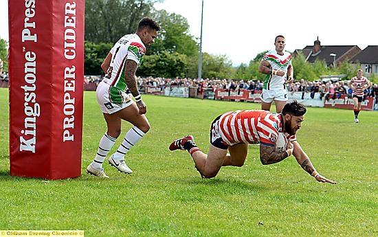 SAFELY OVER . . . Sammy Gee scores Oldham’s opening try.