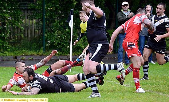 OVER WE GO . . . James Whalley dives in to put Saddleworth Rangers ahead against Kells OVER WE GO . . . James Whalley dives in to put Saddleworth Rangers ahead against Kells