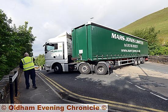 GOING nowhere . . . the lorry blocks Oldham Road, in Greenfield, after the rear of the trailer (right) struck the railway bridge GOING nowhere . . . the lorry blocks Oldham Road, in Greenfield, after the rear of the trailer (right) struck the railway bridge