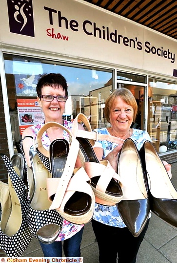 DESIGNER bargains . . . shop manager Carol Forshaw (left) and volunteer Kathryn Frankland with the shoes DESIGNER bargains . . . shop manager Carol Forshaw (left) and volunteer Kathryn Frankland with the shoes