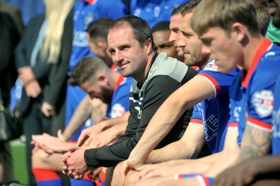 ALL SMILES: Darren Kelly jons theline-up for the team photoshoot