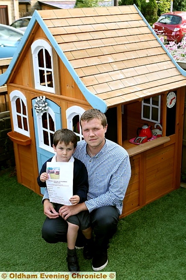 Jacob, his dad Michael, and the house at the centre of the row Jacob, his dad Michael, and the house at the centre of the row