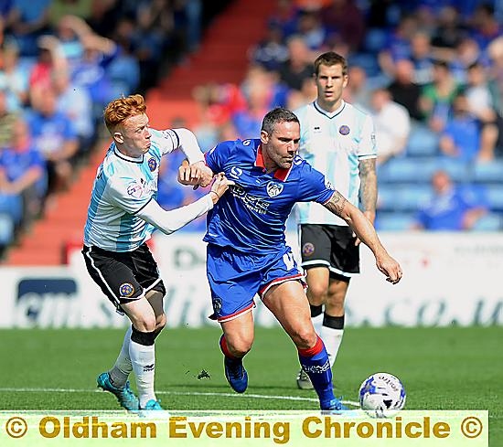 BATTLE FOR THE BALL: Shrews star Ryan Woods (left) tussles with Athletic’s David Dunn in last month’s meeting