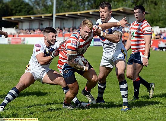 Danny Langtree drives through the Swinton players Danny Langtree drives through the Swinton players