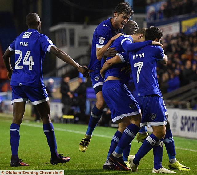 CELEBRATION TIME . . . Lee Erwin is mobbed by his Athletic team-mates after scoring