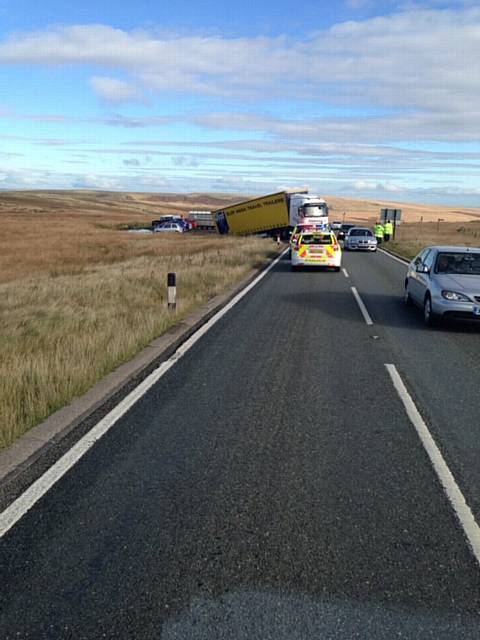 POLICE on the scene as the lorry remains stuck in the mud