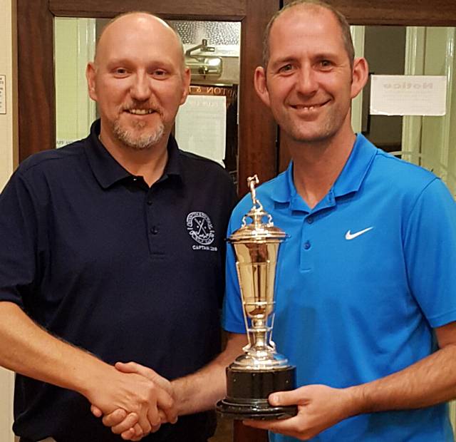 ALL YOURS: Gary Melling receives the Crompton and Royton Club Championship trophy from captain Barry McLoughlin ALL YOURS: Gary Melling receives the Crompton and Royton Club Championship trophy from captain Barry McLoughlin