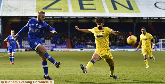 WING MAN . . . Athletic's Ryan McLaughlin fires in a cross despite the attention of a Dons rival