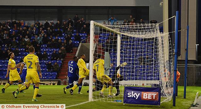 DID THE BALL CROSS THE LINE? . . . Freddie Ladapo's header bounces down off the crossbar in the 89th minute against the Dons, but appeals for a goal were waved away
