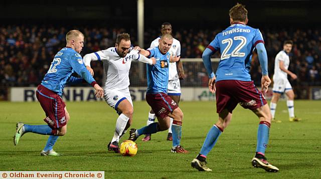 MAN IN THE MIDDLE . . . Lee Croft gets to grips with two Scunthorpe rivals