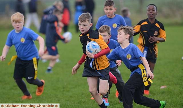 PURPOSEFUL RUN . . . St Edwards' Alfie Maders charges forward in a match against Mills Hill