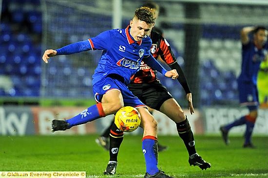 Brad Kay holds off his Bournemouth opponent. Brad Kay holds off his Bournemouth opponent.