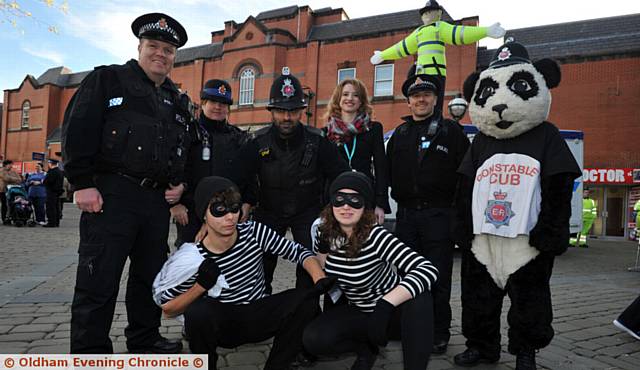 Oldham Police launch their Christmas shoplifting and safety campaign in Oldham Town Centre. PIC shows back L-R: Sgt Danny Atherton, PCSO Sue Pealin, PC Zahid Iqbal, Sara Hewitt (Town Centre Manager), PC Damieon Hartley-Pickles, Constable Cub.Front are robbers from Oldham Theatre Workshop. 