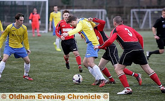 MAKING HIS PRESENCE FELT: Royton’s Alan Beckett (centre) is in the thick of the action against Hindsford. MAKING HIS PRESENCE FELT: Royton’s Alan Beckett (centre) is in the thick of the action against Hindsford.