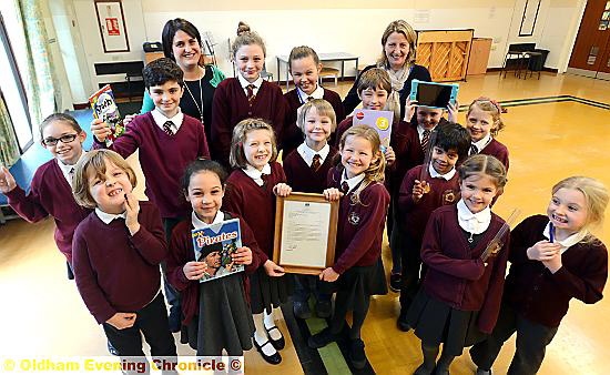 OUTSTANDING . . . head teacher Elizabeth Travis (back left), deputy head Deborah Hodgin (back right) and pupils show off the letter from Schools Minister Nick Gibb