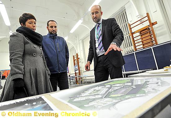 Parents Laura Holgate-Condron, Lee Condron and Barney Harle, Oldham Council’s capital works and energy manager, study the scheme. Picture: Darren Robinson