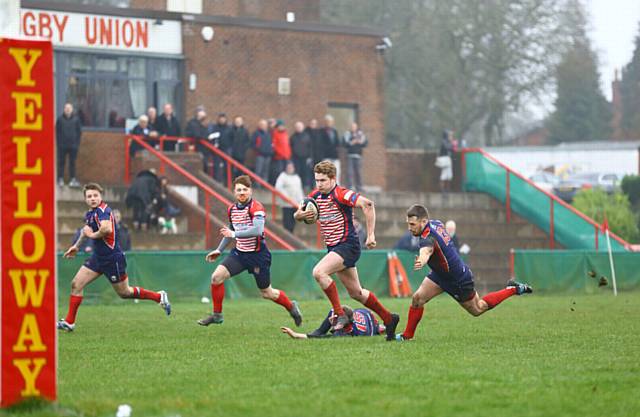 RUNNING THROUGH . . . Ryan Pickles heads for the line to put Oldham back in front