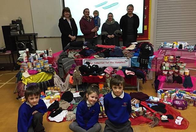 Mather Street Primary School held a special assembly for Olivia Westlake who has been helping the homeless. Back, from left, headteacher Sally Brown, parents Ben Westlake and Claire Westlake, and Mark Baxendale from Streets Ahead. Front, from left, George, Olivia and Jamie Westlake