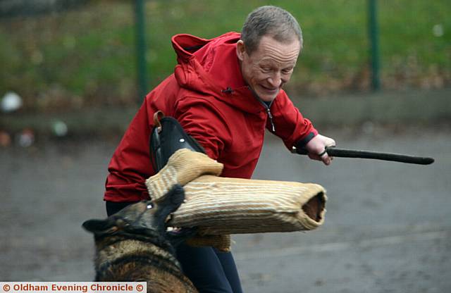 GEE whiz . . . police dog Gee tackles deputy head teacher Steve Hill