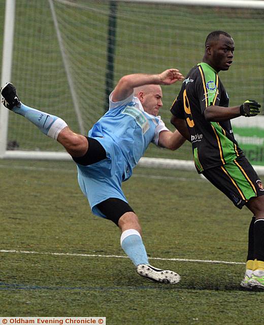 FULL STRETCH . . . Heyside's Brad Dowling (left) dives in to make a challenge during his side's First Division goalless draw against Atherton Town
