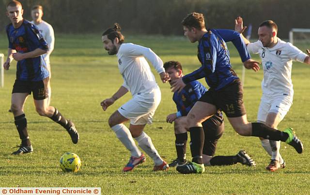 MAKING A BREAK . . . Springhead's Ryan Fagan (white strip) runs with the ball against Avro. 