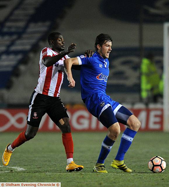 DEFENDER Cameron Burgess is put under pressure
