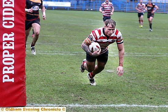 TOUCH DOWN . . . Danny Langtree dives in underneath the posts
