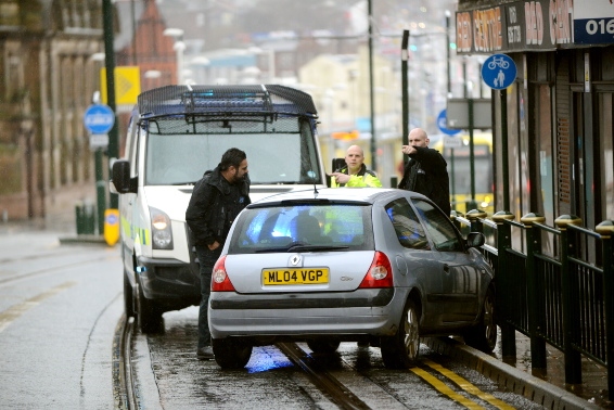 POLICE arrive to deal with the car, which had mounted the kerb and collided with the railings on Union Street
