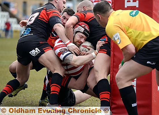 Oldham’s Michael Ward is held up just short of the line by a clutch of Kells defenders. PICTURE by TIM BRADLEY
Oldham’s Michael Ward is held up just short of the line by a clutch of Kells defenders. PICTURE by TIM BRADLEY
