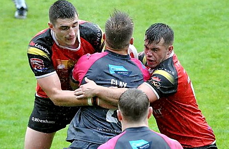 NEW signing Joe Burke (left) helps to stop Adam Clay last season NEW signing Joe Burke (left) helps to stop Adam Clay last season