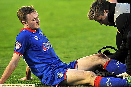 PAINFUL . . . Carl Winchester receives treatment before being substituted.