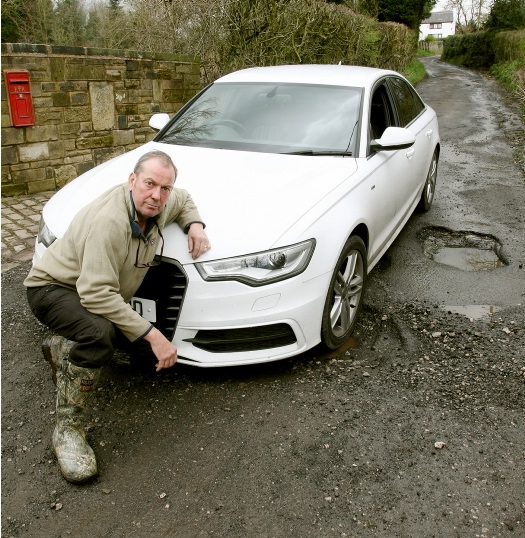 Ian Crowther has to drive over deep potholes every time he leaves his home Ian Crowther has to drive over deep potholes every time he leaves his home