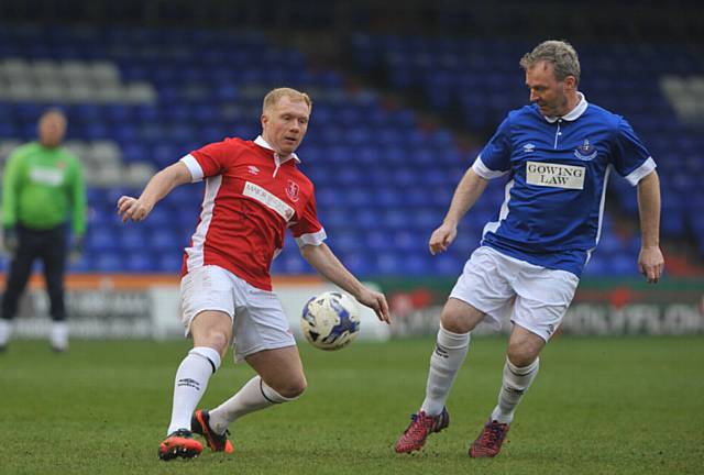 My ball... Man United legend Paul Scholes (left) and Latics boss John Sheridan