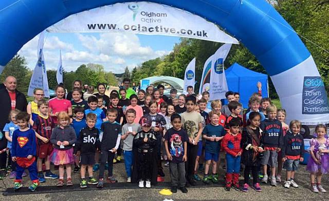 KEEPING FIT . . . children take a break at the finishing line at the Alexandra parkrun.