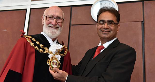 HAND-OVER . . . Derek Heffernan invested as Mayor by the retiring Mayor