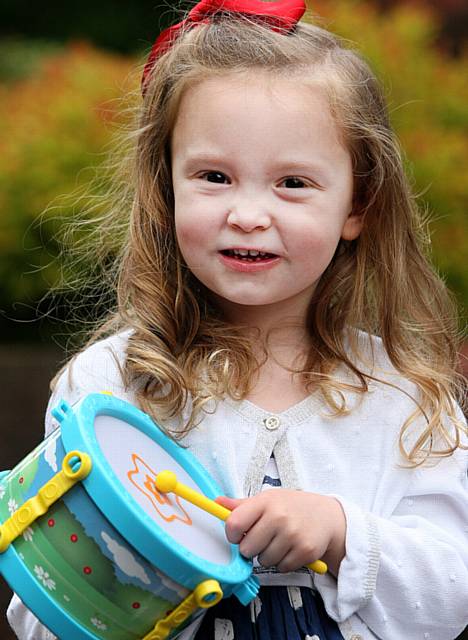 Whit Friday brass band contest at Grotton. Polly Hallas, aged 4, from Oldham, beats her drum to the music.