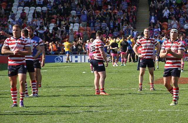 STUNNED . . . Oldham players can't believe it at the final whistle. 