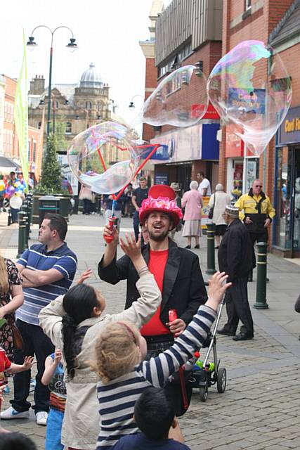 Street entertainment in Oldham town centre. The Bubble Wizard entertains the crowd.