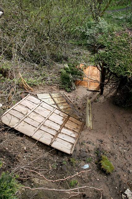 LANDSLIP... garden fence has fallen into the river