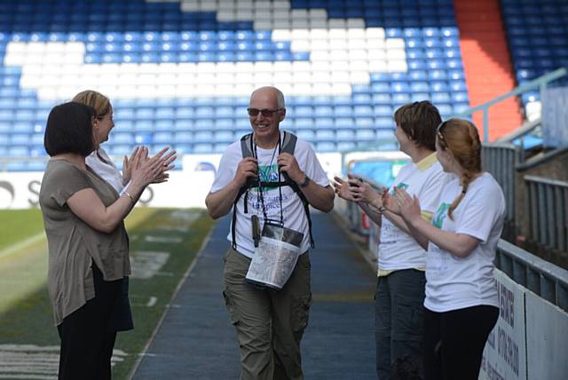 ARRIVAL...Nick Tamblyn finishes his 5-day walk from Birmingham to Oldham Athletic to cheers from his family and friends.