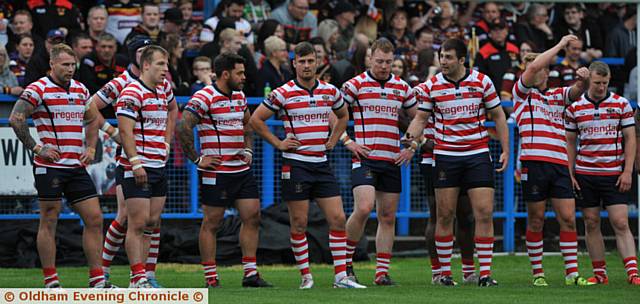 DOWN IN THE DUMPS . . . Oldham players try to take in the heavy defeat by Bradford Bulls at Bower Fold last night