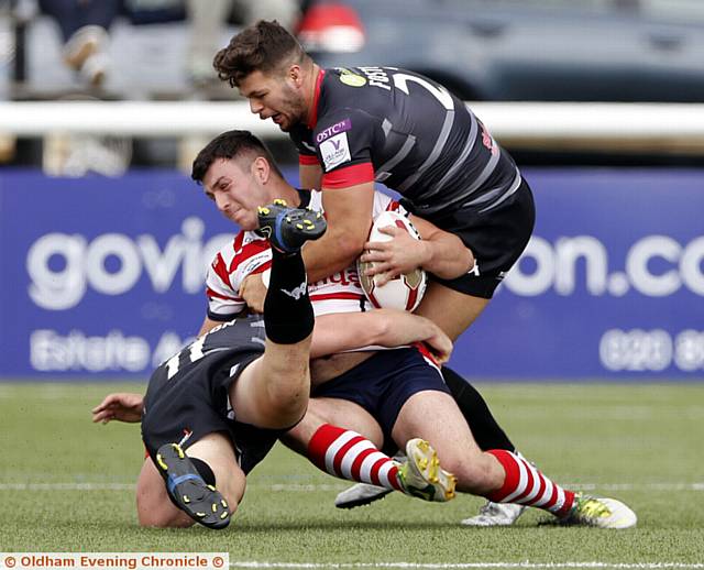 GROUNDED . . . Oldham forward Liam Thompson is brought to the turf by the Broncos defence. 
