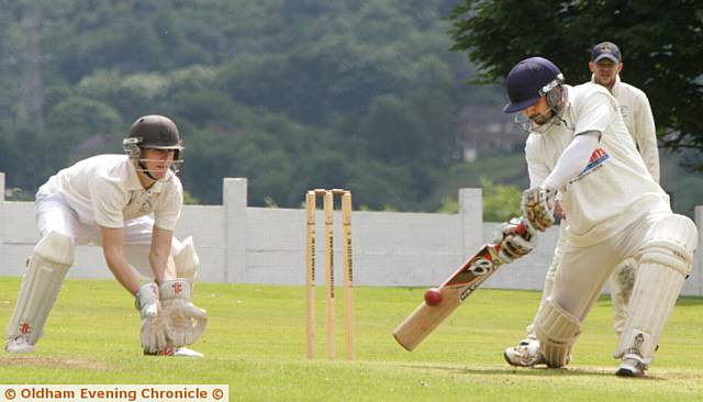 ATTACK . . . Werneth's Ali Muzaffar makes room to launch the ball to the boundary. The skipper made a vital 80