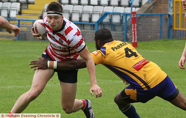 STEPPING IN . . . Young centre Sam Wood tries to skip beyond a tackle