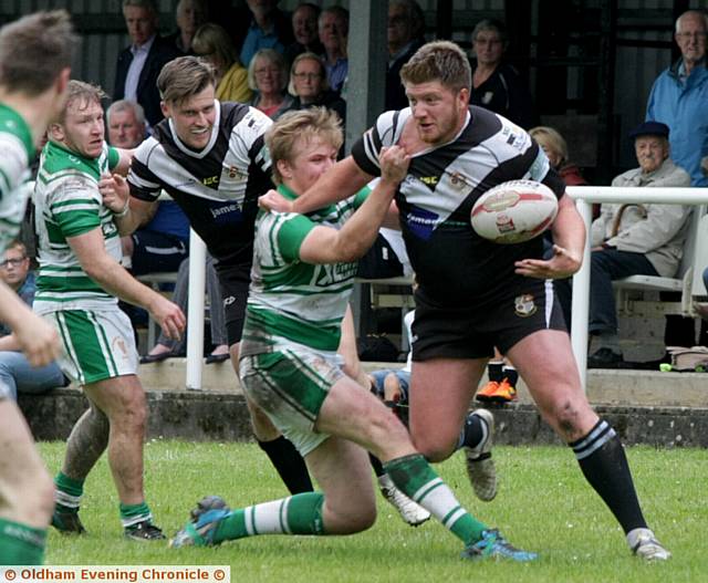 GOING NOWHERE . . . Jack Bradbury, of Saddleworth Rangers, is held by a Dewsbury Celtic opponent.