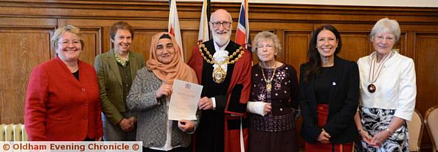 From left, council leader Jean Stretton, Chris Foley, a friend of Marzia Babakarkhail, Marzia,  Mayor Derek Heffernan, Mayoress Di Heffernan, MP Debbie Abrahams and Anne Sykes, Deputy Lieutenant of Greater Manchester
