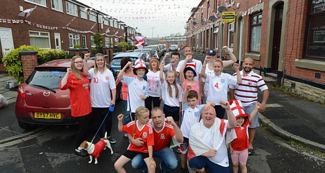 Friendly Euro 2016 rivalry between England and Wales on Wales Street, Watersheddings. Pic shows some of the football-mad residents including front row left to right, Diesel the dog, Amelia Cunningham (8), Welshman Chris Cunningham, Liam Farrand (8), Englishman Chris Farrand, Lacey Johnson (8).