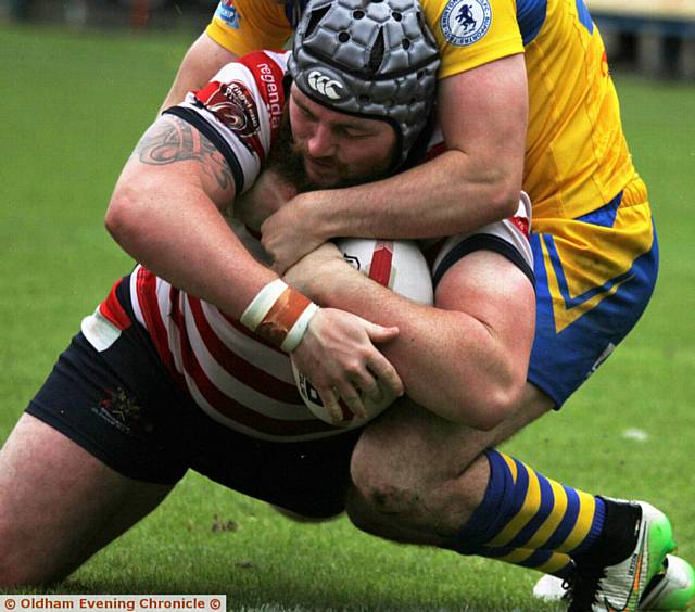 SHOW OF STRENGTH . . . Oldham's Michael Ward forces his way over for his second try of the match against Swinton Lions at Bower Fold 