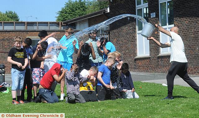 Hathershaw College Summer Fun Week one of the Staff helps keep the Kids cool on the Hottest day of the Year